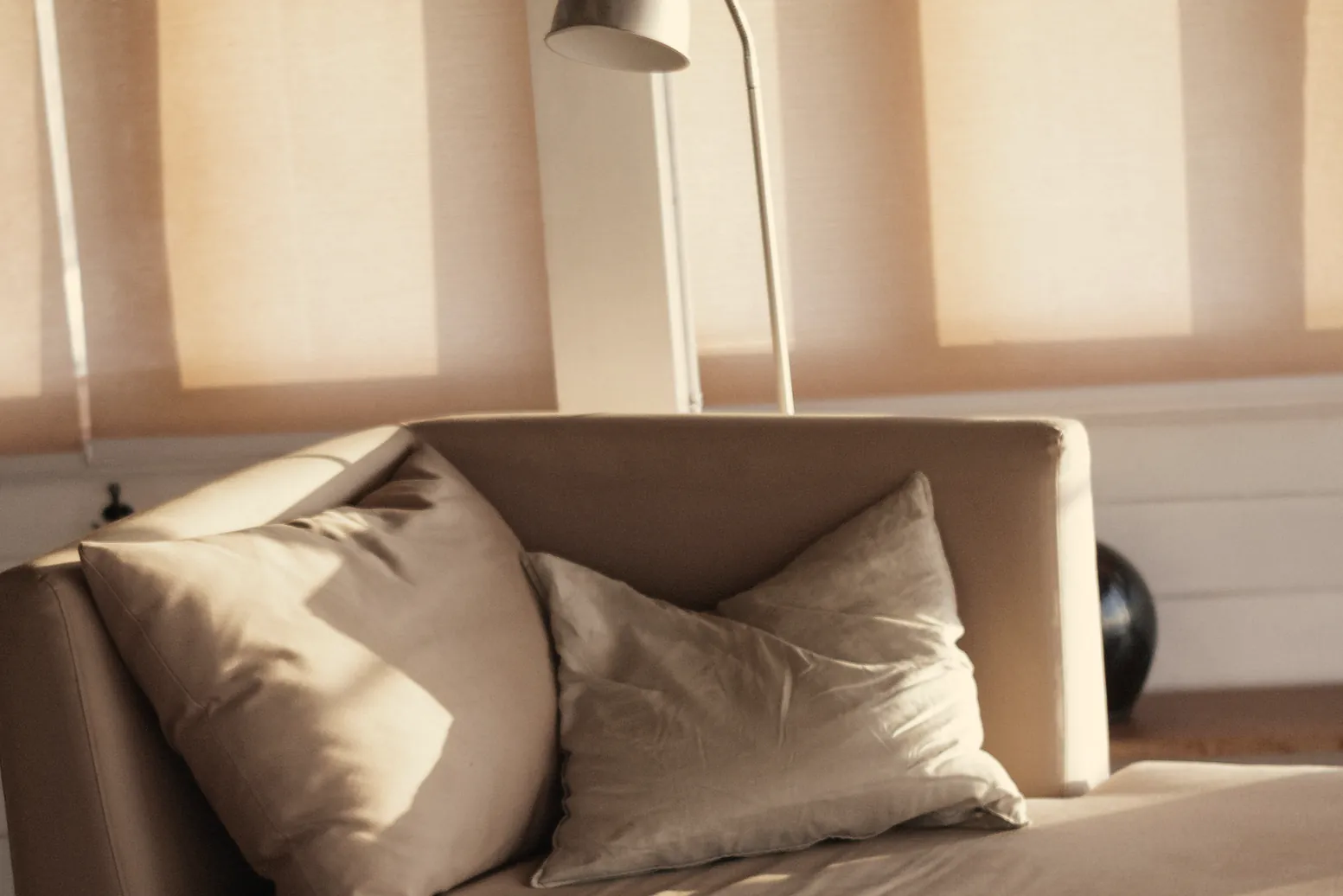 Linen cushions on the daybed by the sea doors in the last of the sun