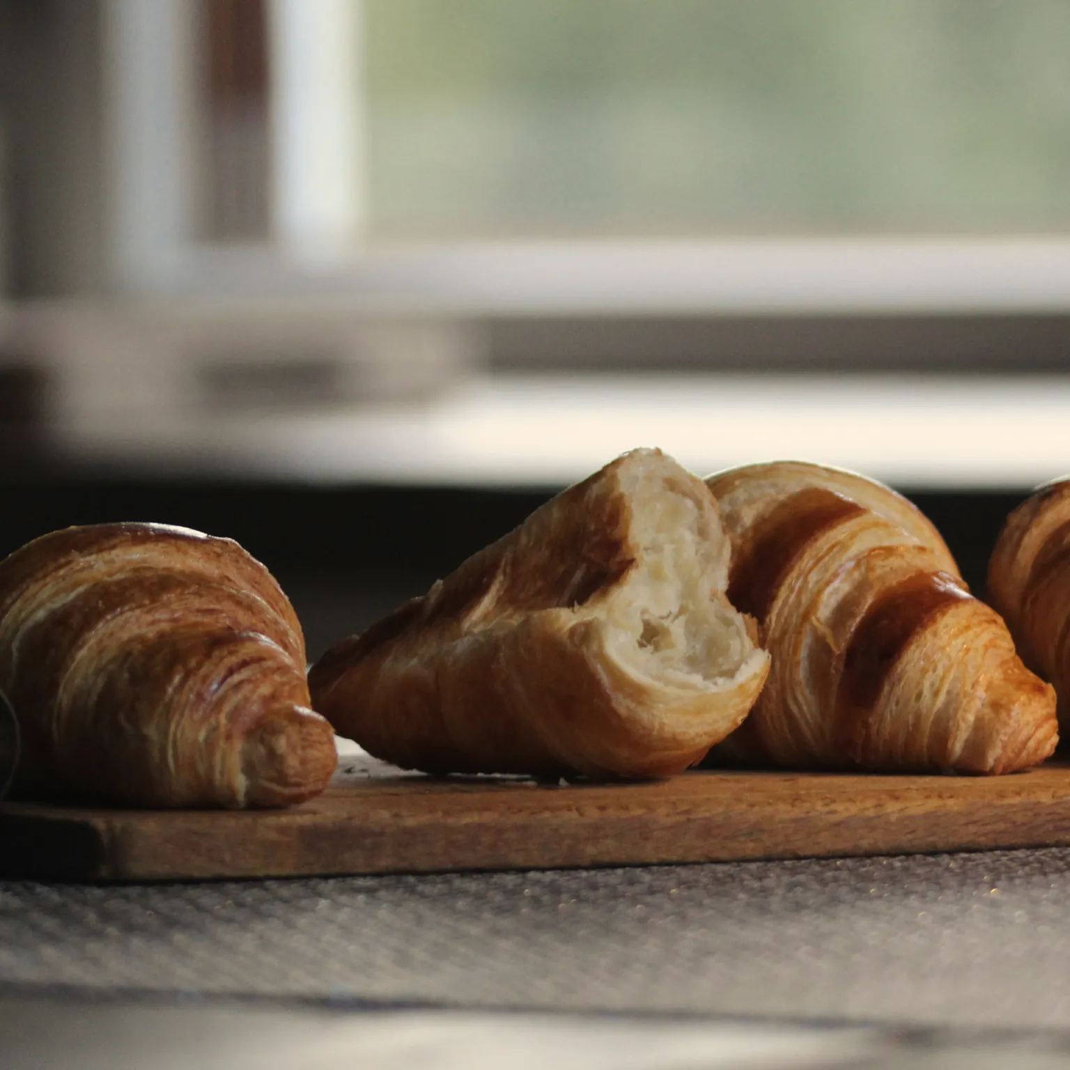 Croissants on a plate by the window